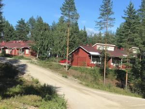 a house on a dirt road next to a road at Koli country club basic 6 in Hattusaari
