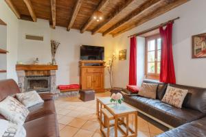 a living room with a couch and a fireplace at Gite Etxaluzenea in Saint-Étienne-de-Baïgorry
