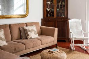 a living room with a couch and a chair at Central Ericeira Apartment with Lift in Ericeira +35 photos