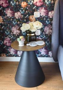 a table with a vase of flowers on it at The Oscar Olympic Hotel in Thessaloniki