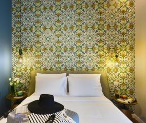 a bedroom with a bed with a hat on it at The Oscar Olympic Hotel in Thessaloniki
