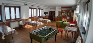 a room with a foosball table and some chairs at Rifugio La Capanna in Claviere