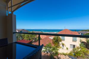 a view from the balcony of a house overlooking the ocean at Beach Haven Executive Apartments in Coffs Harbour