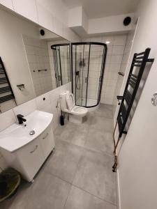 a bathroom with a toilet and a sink and a shower at Kwatery pracownicze Stalowa Wola Nisko in Nisko