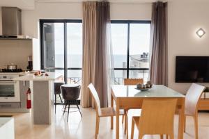a kitchen and dining room with a table and chairs at Sun Island Apartments in Funchal