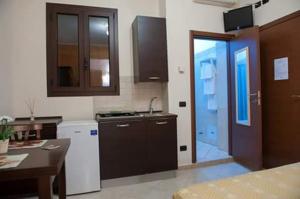 a kitchen with a sink and a door to a room at B&B Vittorio Emanuele ll in San Cesario di Lecce