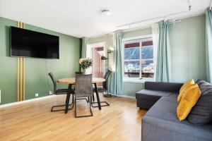 a living room with a couch and a table at Flåmsbrygga Apartments in Flåm