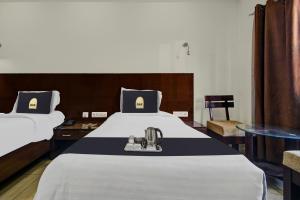 a hotel room with a bed with a sewing machine on it at Super Townhouse OAK HOTEL Heritage Heights in Jaipur