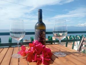 a bottle of wine and two glasses on a table at Casa Bettina in Pizzo