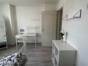 a bedroom with a bed and a table and a desk at Luxe villa in Ostend