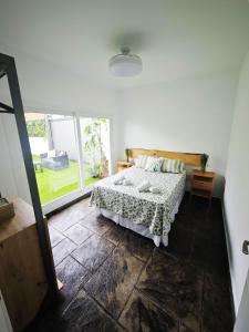 a bedroom with a bed and a large window at Villa Rural Nuestro Rincón in Sanlúcar de Barrameda