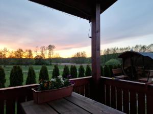 a porch with a view of the sunset at Domek Na Roztoczu in Kaczórki