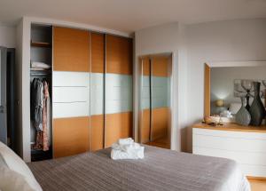 a bedroom with a bed and a closet at Sun Island Apartments in Funchal