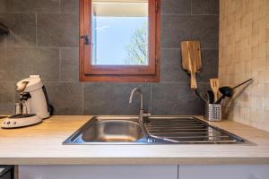 a kitchen counter with a sink and a window at Le Grenier de Fernand - vue montagne in Saint-Jean-de-Sixt