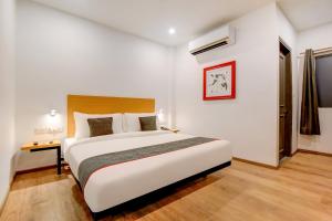 a bedroom with a large white bed in a room at Collection O Near Kohat Enclave Metro Station in New Delhi +40 photos