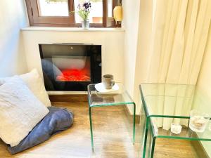 a living room with a fireplace with a couch and a table at La Casina de Cudillero in Cudillero +32 photos