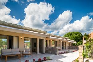 a patio of a house with chairs and tables at Phos Elegant Residences by Konnect, 400m to the beach in Dassia