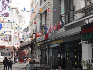 Una calle de la ciudad con un montón de edificios con banderas. en clove silvana hotel, en Eskiömerler