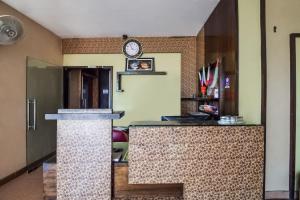 a room with a counter with a clock on the wall at Hotel O Hadoti Resort in Bhilwara