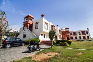 a motorcycle parked in front of a building at Hotel O Hadoti Resort in Bhilwara