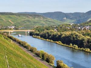 a bridge over a river with a boat on it at WineDream in Brauneberg