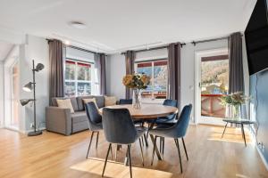 a dining room and living room with a table and chairs at Flåmsbrygga Apartments in Flåm +25 photos