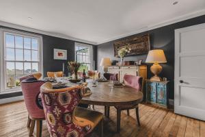 a dining room with a table and chairs at Little Redlap - Delightful views near Dartmouth in Dartmouth