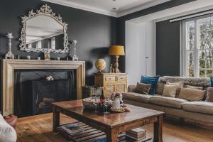 a living room with a couch and a table at Little Redlap - Delightful views near Dartmouth in Dartmouth