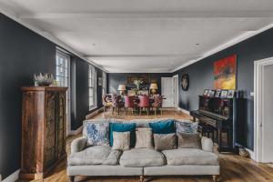 a living room with a couch and a table at Little Redlap - Delightful views near Dartmouth in Dartmouth