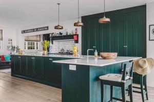 a kitchen with green cabinets and a white counter at Little Redlap - Delightful views near Dartmouth in Dartmouth