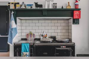 a kitchen with a stove top oven in a room at Little Redlap - Delightful views near Dartmouth in Dartmouth
