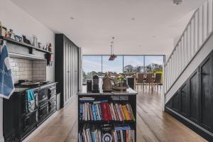 a kitchen with a stove and a book shelf with books at Little Redlap - Delightful views near Dartmouth in Dartmouth