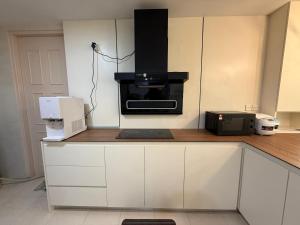 a kitchen with a counter with a stove top oven at OT7 Eleven Santubong Suites in Kuching