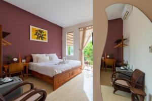 Postel nebo postele na pokoji v ubytování Green Town House Hoi An