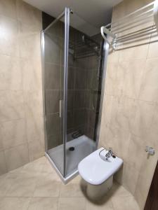 Un baño con ducha, inodoro y lavabo. en Apartamento San Roque, en Finisterre