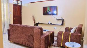 a living room with a couch and a table at CesRah Homes in Mombasa