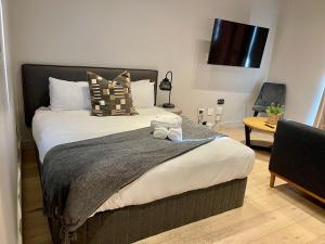 a bedroom with a bed with two towels on it at The Tokyo 1211 in Cape Town +9 photos