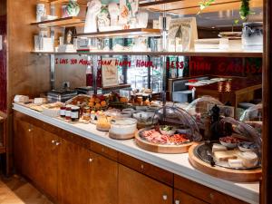 a buffet line with many different types of food at Hôtel La Conversation in Paris
