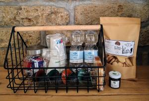 a basket filled with bottles and other items on a table at Residenze del Bosco - The Lab in Tuscania +14 photos