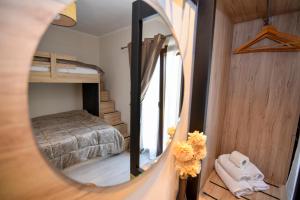a mirror in a room with a bunk bed at Dimitra House in Stavros