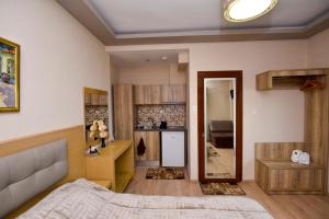 a bedroom with a bed and a kitchen at Dimitra House in Stavros