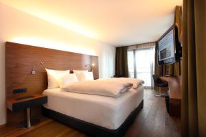Voodi või voodid majutusasutuse AlpenParks Hotel & Apartment Taxacher toas