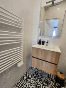 a bathroom with a sink and a mirror at Forest Studio - Ground Floor - City Center - Train station 5 minutes away in Charleville-Mézières