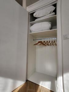 a walk in closet with white towels and a mirror at Forest Studio - Ground Floor - City Center - Train station 5 minutes away in Charleville-Mézières