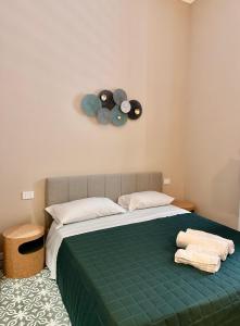 a bedroom with a bed with two towels on it at Dimora Aquae Suites&Spa in Mola di Bari +119 photos