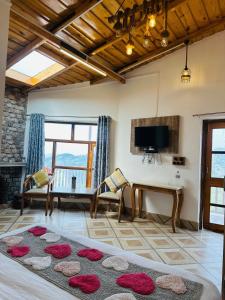 Una sala de estar con una mesa y sillas y un televisor. en The Frozen Valley 4BHK Villa, en Mukteshwar 8 fotos más