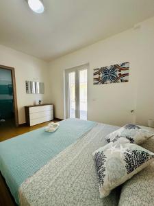 a bedroom with a large bed with two pillows at Domus Apartament in Capo dʼOrlando