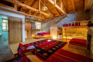 a bedroom with two bunk beds and a rug at BabaNu Guesthouse in Nënshat