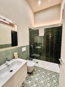 a bathroom with a sink and a toilet and a tub at Dimora Aquae Suites&Spa in Mola di Bari
