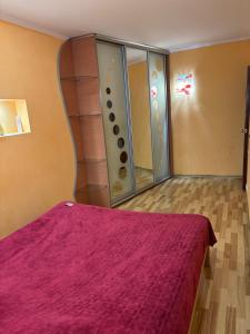 a bedroom with a bed with a red blanket at Квартира в центрі на Волі 8А in Luts'k